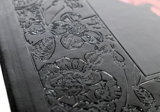 Embossing and debossing tactile finish for paper packaging and labels