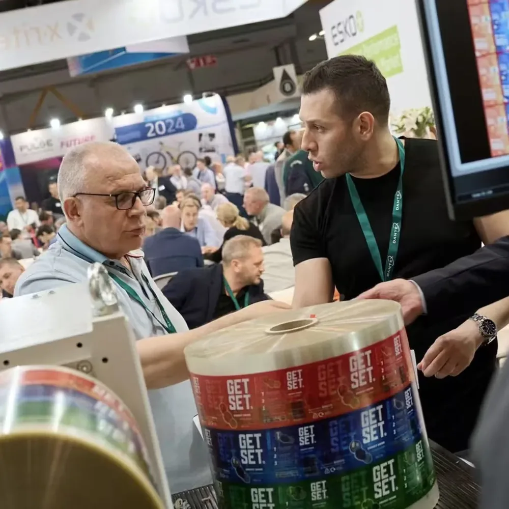 Packaging project discussion with printed label rolls for production resource review