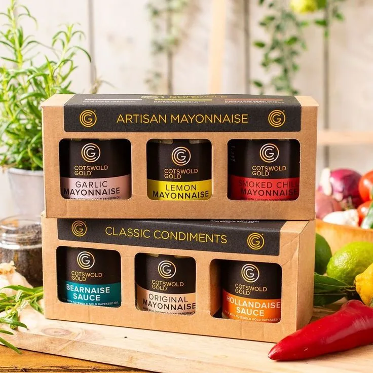 Food and condiment jars packed in printed paperboard retail packaging with product labels